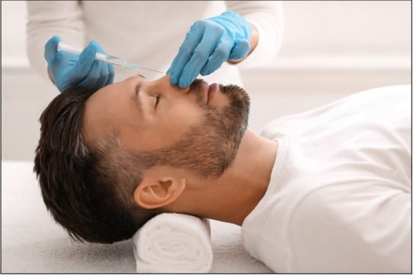Male patient undergoing non-surgical rhinoplasty nose correction treatment at MicroCare ENT Hospital Hyderabad